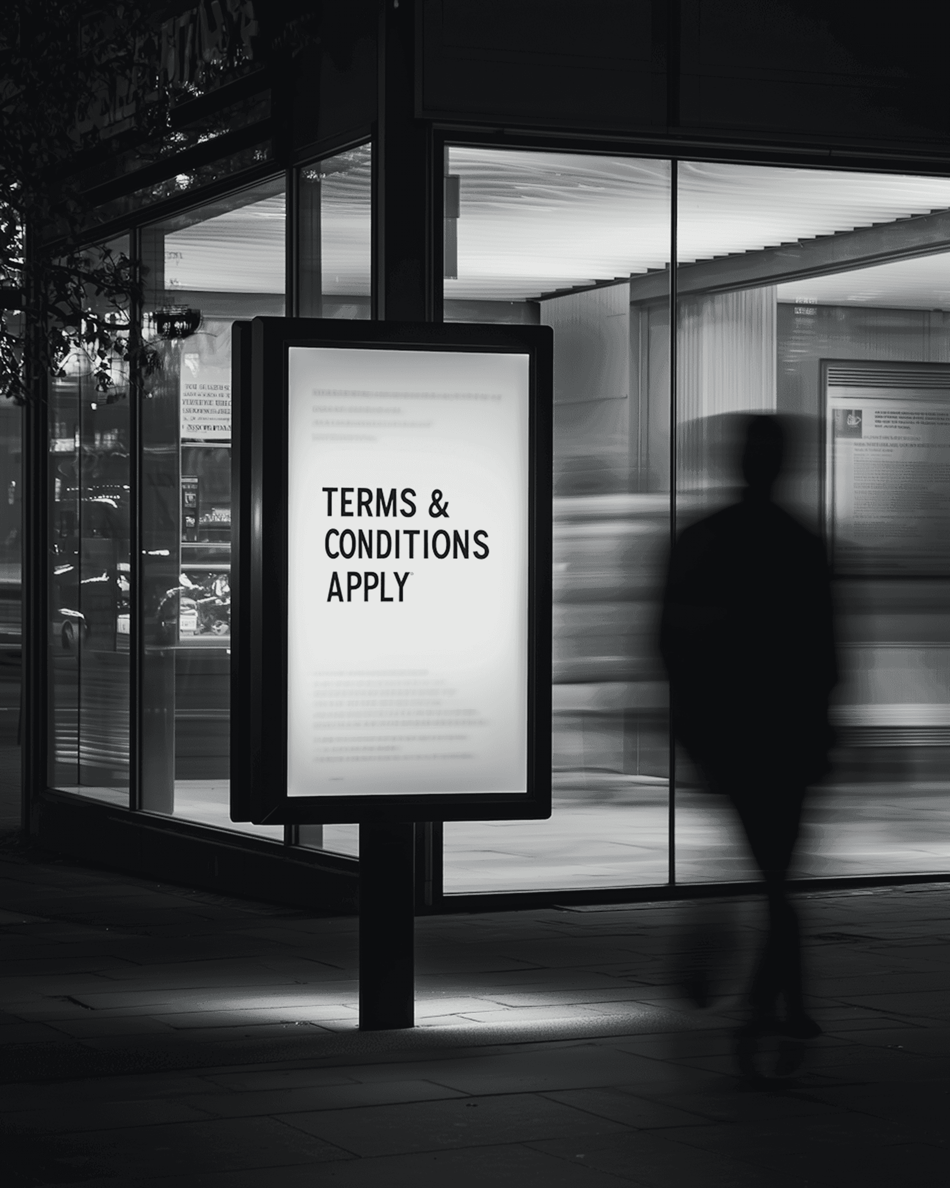 Illuminated street billboard reading Terms & Conditions Apply at night